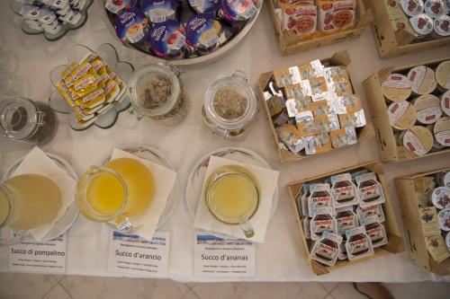 a table topped with plates and bowls of food and drinks at Casa Portofino Rooms&Breakfast in Cesenatico