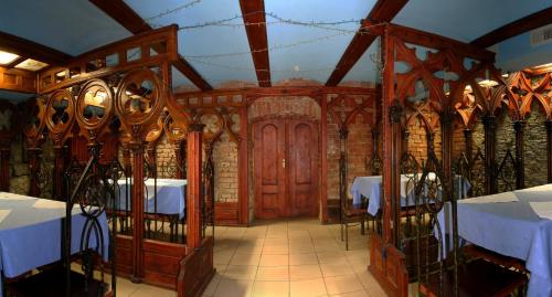 a dining room with tables and a wooden door at Complex Vivcharyk in Skole