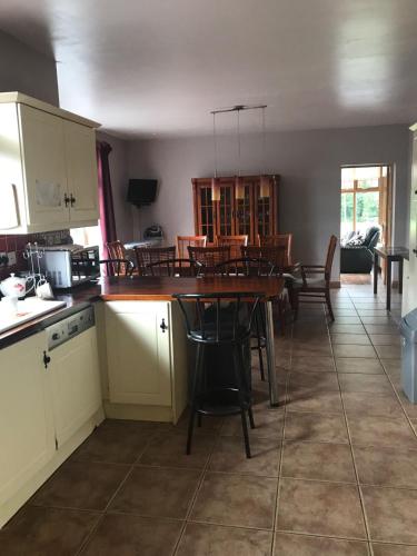 a kitchen and dining room with a table and chairs at Riverdale in Carlingford