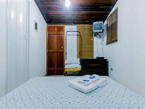 Säng eller sängar i ett rum på Ilha House Suítes