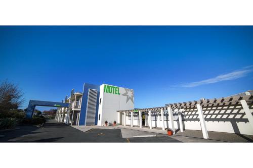 a building with a trump sign on the side of it at Northstar Motel in Oamaru