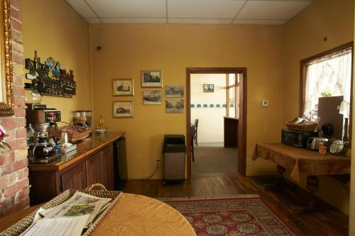 a living room with a table and a doorway at The Courtland Hotel & Spa in Fort Scott