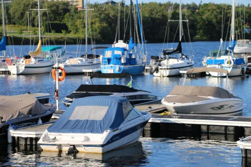 a group of boats docked at a dock in the water at Maison du lac in Lac-Mégantic