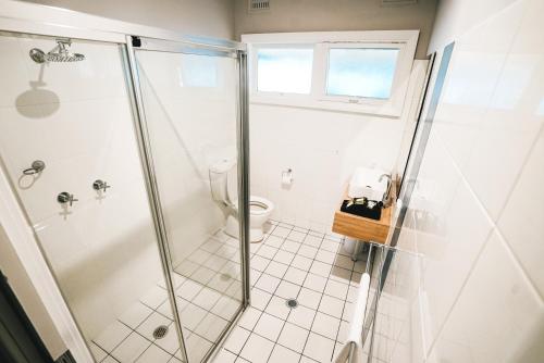 a bathroom with a shower and a toilet at The Greenroof in Newcastle