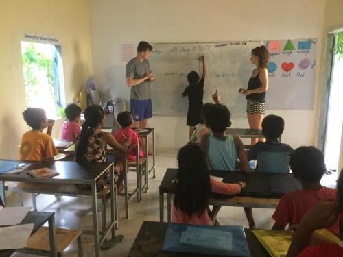 a group of children in a classroom with a teacher at Bunyong Homestay in Siem Reap