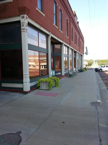 an empty sidewalk in front of a brick building at The Courtland Hotel & Spa in Fort Scott