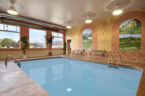 a large swimming pool in a building with windows at Days Inn by Wyndham Penticton Conference Centre in Penticton