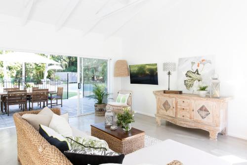 a living room with a couch and a table at Satara Byron Bay - Adults Only in Byron Bay