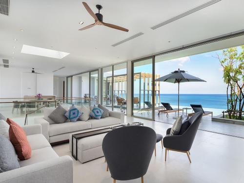 an open living room with a view of the ocean at Malaiwana Residences in Nai Thon Beach