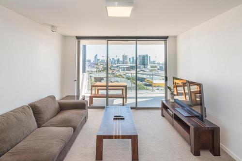 a living room with a couch and a table at Eastwood Apartments in Brisbane