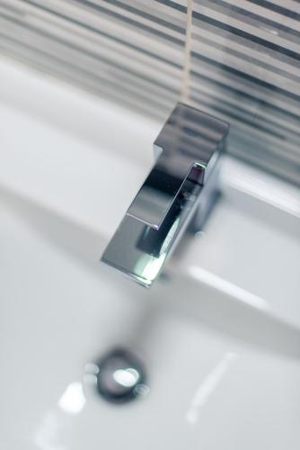 a close up of a bathroom sink with a mirror at Grand Hôtel in Sainte-Foy-la-Grande