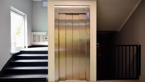 a hallway with a door leading up to a staircase at Hotel Felix in Kraków