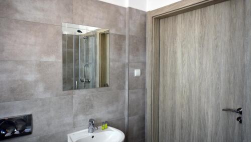 a bathroom with a sink and a mirror at Hotel Felix in Kraków