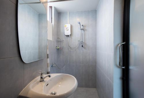 a bathroom with a sink and a shower at Mountain View GuesthouseChiangmai in Chiang Mai