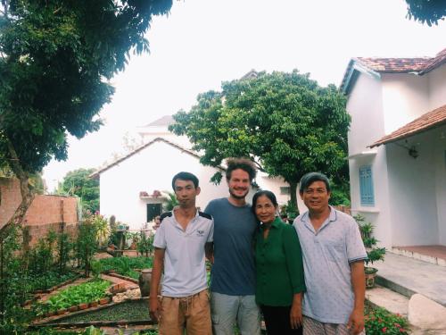 a group of people standing in front of a house at Vietnam Phuot Real Home in Kon Tum
