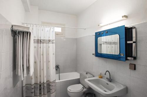 a bathroom with a toilet and a sink at Villa Marinos in Kato Korakiana