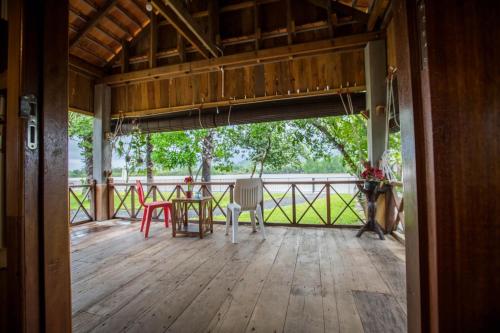 a view of a porch with a table and chairs at Kampot River Residence in Kampot