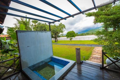 a view of a swimming pool from the inside of a house at Kampot River Residence in Kampot