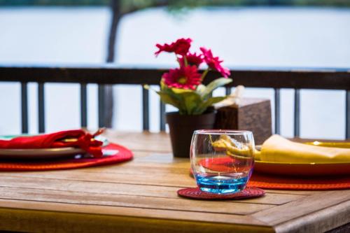 a wooden table with a glass of water on it at Kampot River Residence in Kampot