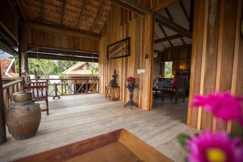 a porch of a house with a vase and flowers at Kampot River Residence in Kampot