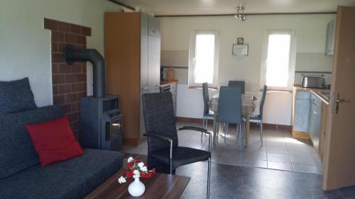 a living room with a couch and a stove at Ferienhaus Storchenweg in Mahlzow
