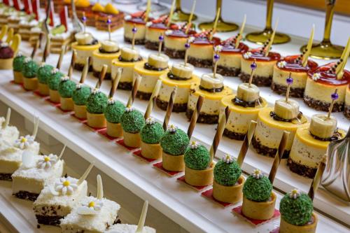 a display of desserts and pastries on a table at Royal Holiday Palace in Lara