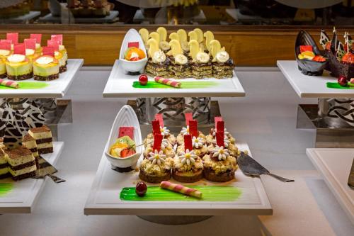 a table with many different types of desserts on display at Royal Holiday Palace in Lara