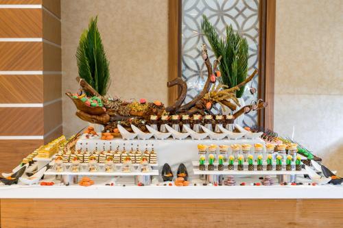 a display of food on a table in a room at Royal Holiday Palace in Lara