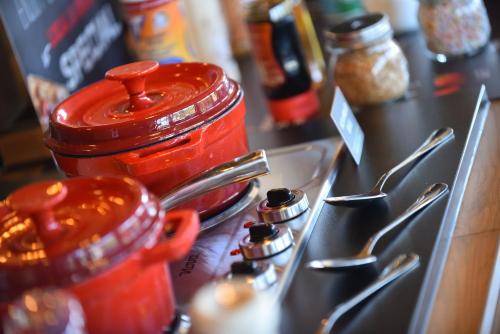 a jar of jam sitting on top of a counter with spoons at Ibis Brussels Erasmus in Brussels