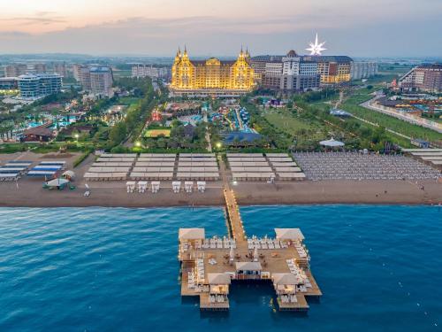 an aerial view of a city with a pier in the water at Royal Holiday Palace in Lara
