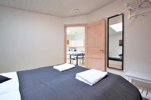 a bedroom with a bed with two pillows on it at Odinn Reykjavik Odinsgata Apartments in Reykjavík