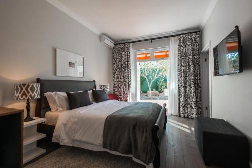 a bedroom with a large bed and a window at Waterstone Lodge in Somerset West