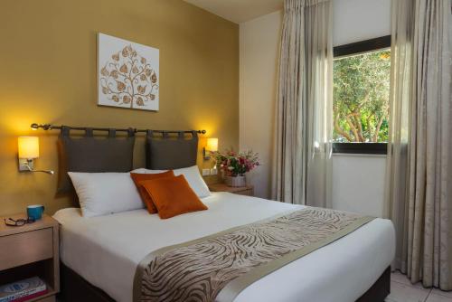 a bedroom with a large bed and a window at Rafael Residence Boutique in Jerusalem