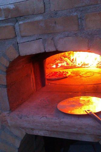 a pizza oven with two pizzas in it at Casa Edith in Libano