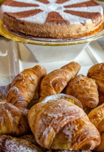 a bunch of croissants and other pastries on a tray at Pisa Holidays in Pisa
