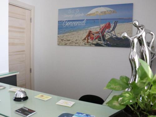 an office with a desk with a picture on the wall at B&B Vacanze Salento in Torre San Giovanni Ugento