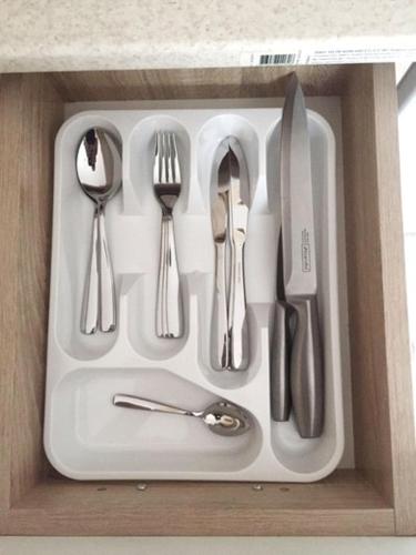 a white tray with utensils in a drawer at Polyana Apart in Polyana
