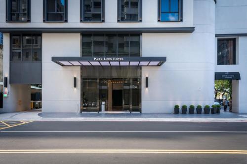 a building with a sign on the front of it at Park Lees Hotel in Kaohsiung