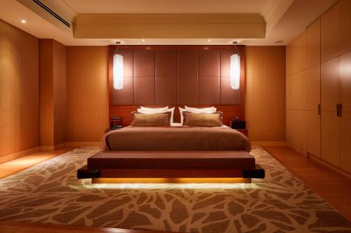 a bedroom with a large bed with a large headboard at Shima Kanko Hotel The Bay Suites in Shima