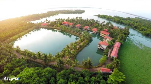 an aerial view of a resort in the middle of a lake at Kalathil Lake Resort in Vaikom