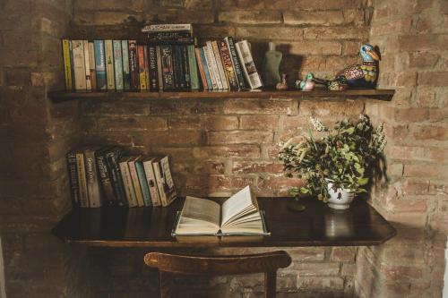 a table with an open book on a brick wall at Agriturismo Zampugna in Montefollonico