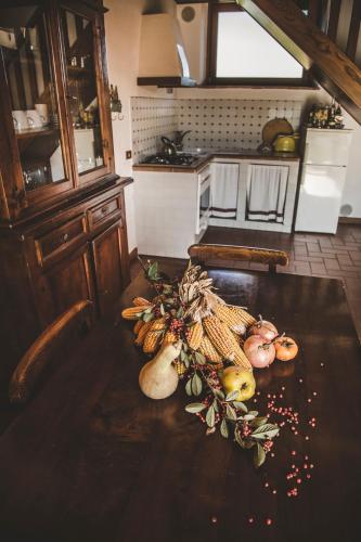 a kitchen with a table with vegetables on it at Agriturismo Zampugna in Montefollonico