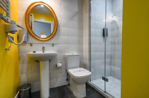 a bathroom with a toilet and a sink and a mirror at Royal Tennis Club in Marbella