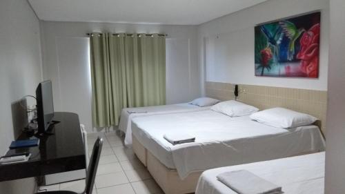 מיטה או מיטות בחדר ב-Hotel Parnaiba
