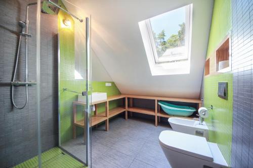 a bathroom with a shower and a toilet and a sink at Villa Arkadia in Łukęcin