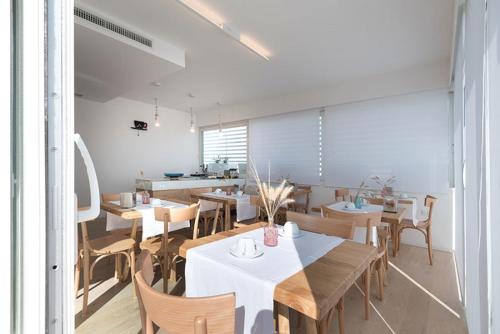 a dining room with wooden tables and chairs at B&B Il Palazzotto di Luca Luxury Suites in Lecce