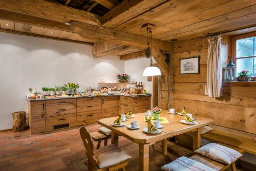 a dining room with a table and a kitchen at Wimmerhof in Höslwang