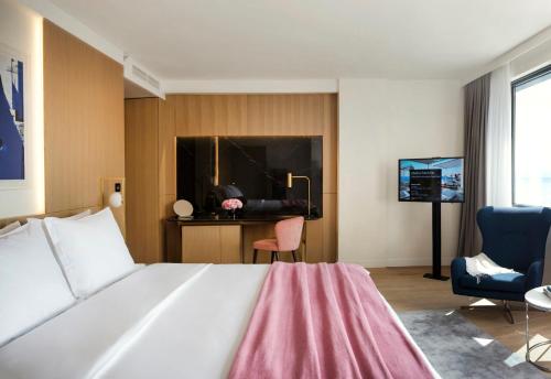 a bedroom with a bed and a desk and a chair at Hotel Excelsior in Dubrovnik