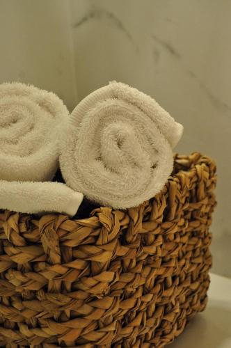 a basket filled with towels on a table at Le Biblo Suites & Apart in Montevideo