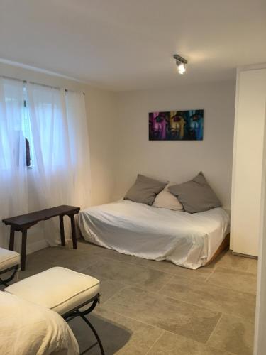 a bedroom with two beds and a table and a window at Private luxury retreat in Sible Hedingham